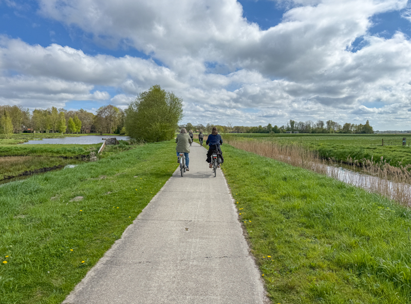 Two distant figures riding on Dutch cycleway
